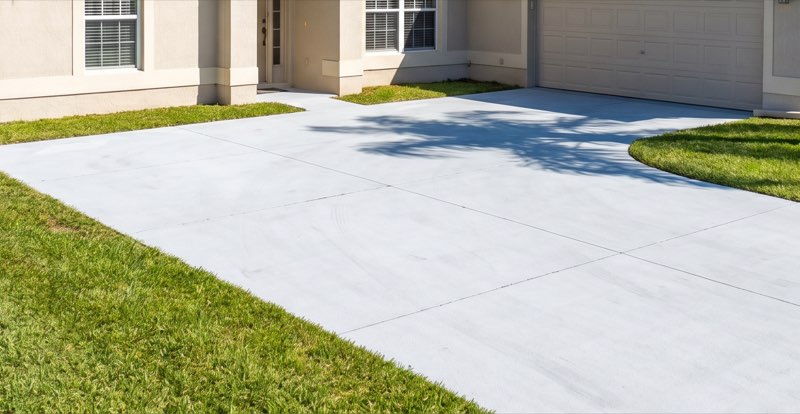 Driveway in Legacy Park after pressure washing — uniform pale concrete