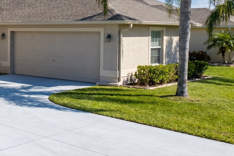 Stucco wall and garage door in ChampionsGate after soft washing — bright and stain-free